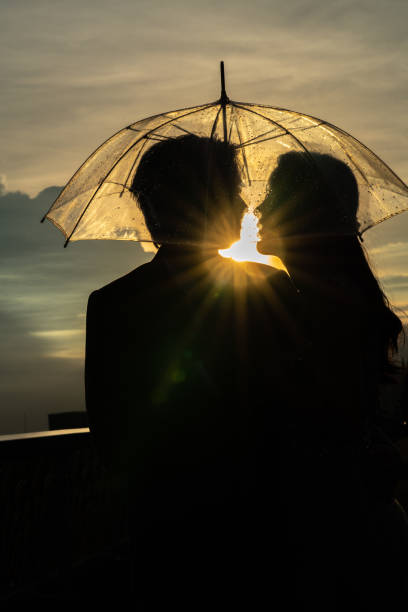 istock Silhouette couple prewedding under umbrella 1155191132