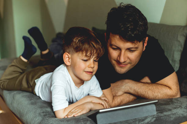 istock Father and son looking at digital tablet 1155191178