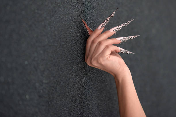 woman hand with long nails, acrylic manicure.