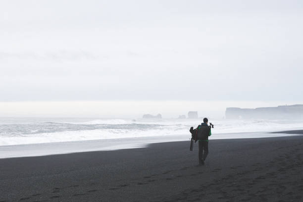 istock photographer in Reynisfjara beach 1155191417