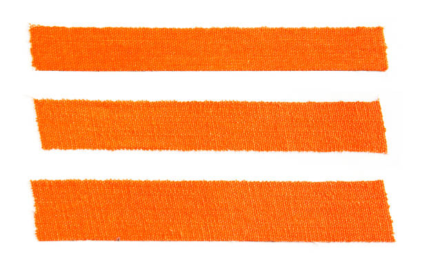 istock Three pieces of orange matte cloth gaffer tape isolated on white background. 1155192535