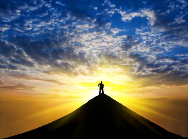 istock man silhouette stay on a mountain top 1155195867