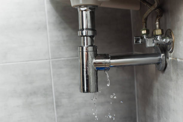 istock Damaged steel pipe in bathroom on grey background 1155196040