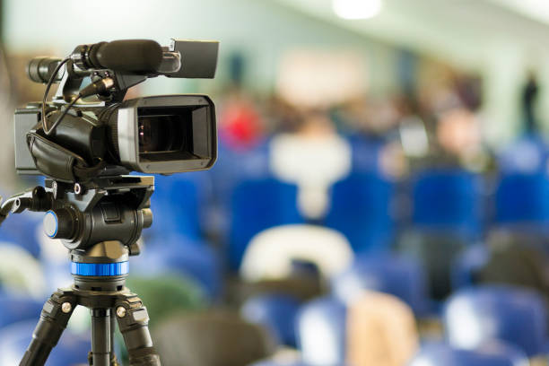 istock Front View of Professional Videocamera. Positioned Against Blurred Background. Horizontal Image 1155199551