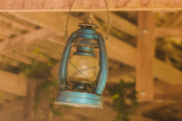 The old blue hurricane lamp hung on the beam