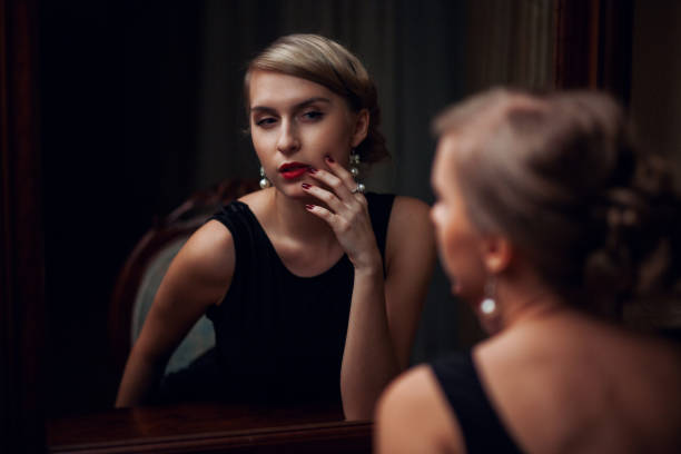 istock Young girl admires reflection in the mirror 1155201387