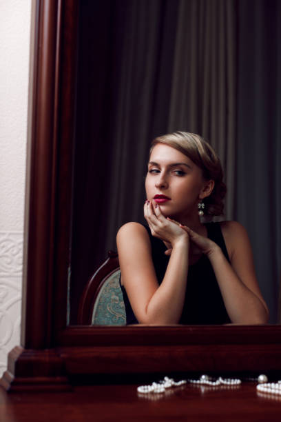 istock Young girl admires reflection in the mirror 1155201404