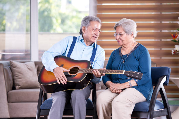istock Senior couple with guitar at home 1155201792