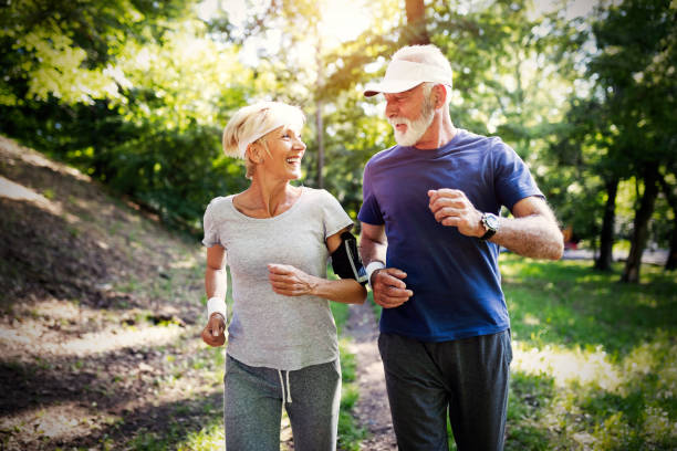 istock Senior couple jogging and running outdoors in nature 1155201865
