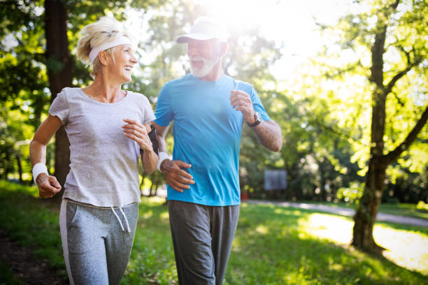 istock Senior couple jogging and running outdoors in nature 1155201957