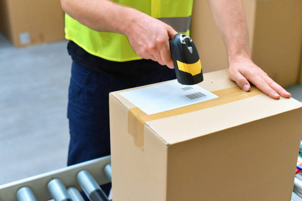 istock workers in the warehouse scanning parcels for retail and transport shipping 1155202052