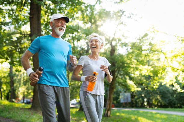 istock Mature couple jogging and running outdoors in nature 1155202136