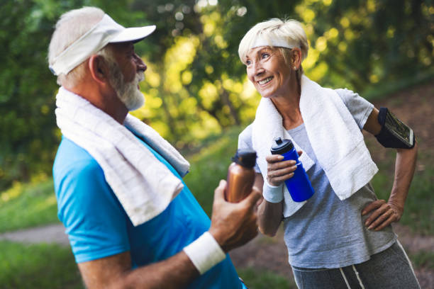 istock Senior couple jogging and running outdoors in nature 1155202939