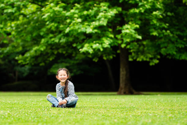 Smiling girl sitting on the grass