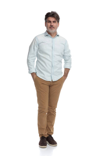 istock Positive casual man holding both hands in his pocket 1155204140