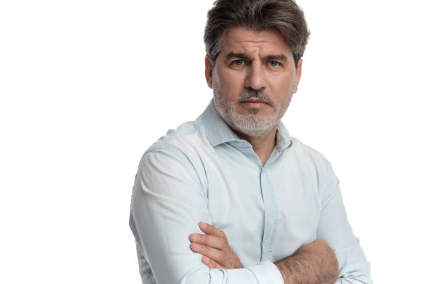 istock Upset old man frowning with his arms folded 1155204299