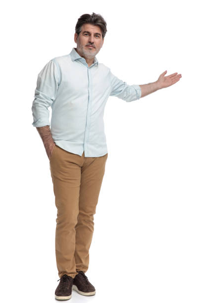 istock Casual man presenting and holding his hand in his pocket 1155205001