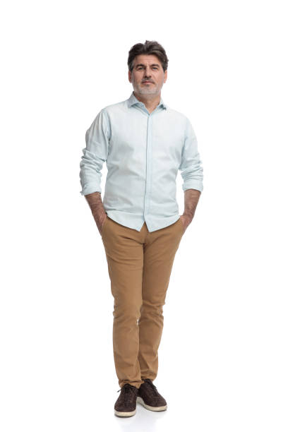 istock Casual old man standing with both hands in his pockets 1155205013