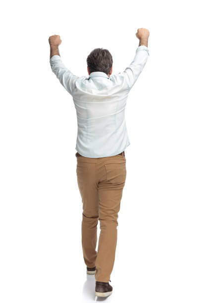 istock Victorious casual man walking forward celebrating 1155205626