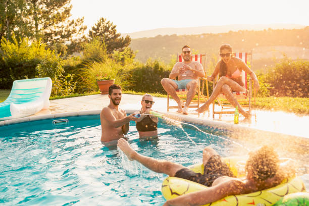 istock Friends having fun at a poolside party 1155205657