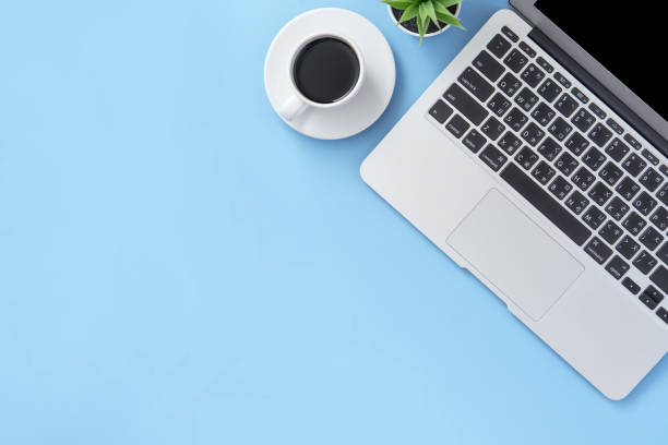 istock Business concept, relaxation in working time, drinking coffee taking a break on clean light blue office table, copy space, flat lay, top view, mockup 1155205934