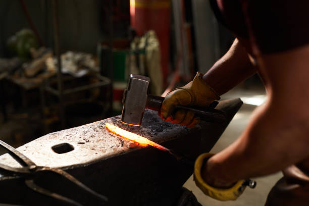 istock Blacksmith shaping heated metal bar 1155206553