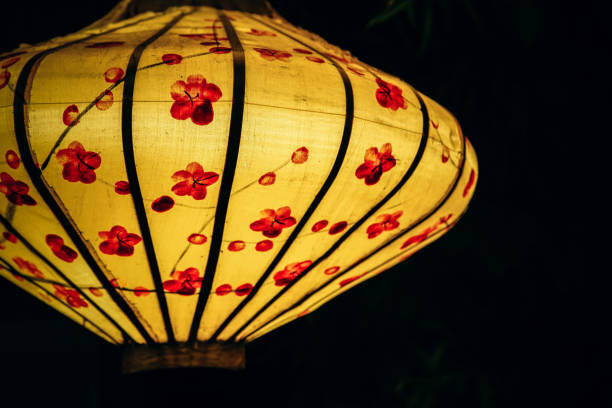 Close-up Shot of a Yellow Lantern with Red Decorations stock photo