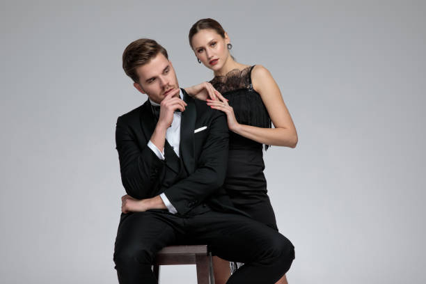 istock Seated groom looking sideways while his girlfriend leans on him 1155208656