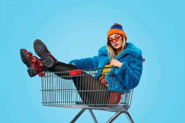 istock Confident weird female in shopping trolley 1155208837