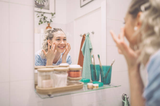 young woman at home - mirror women bathroom make up imagens e fotografias de stock