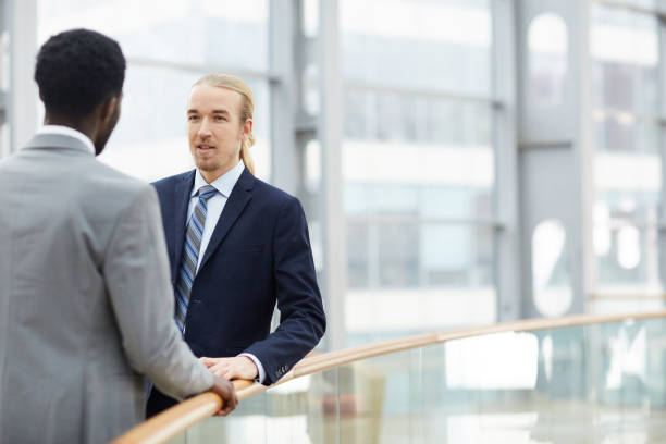 istock Business employees talking in lobby 1155210858