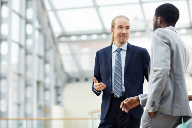 istock Content businessmen chatting in corridor 1155210881