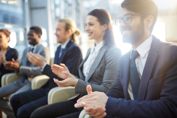 istock Welcoming business speaker with applause 1155212268