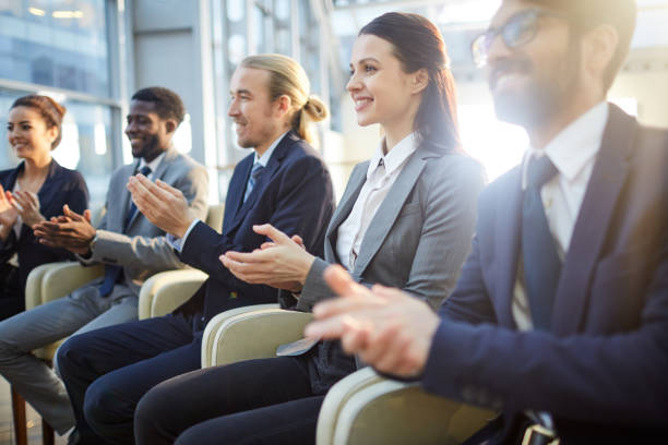 istock Conference participants clapping for business speaker 1155212273