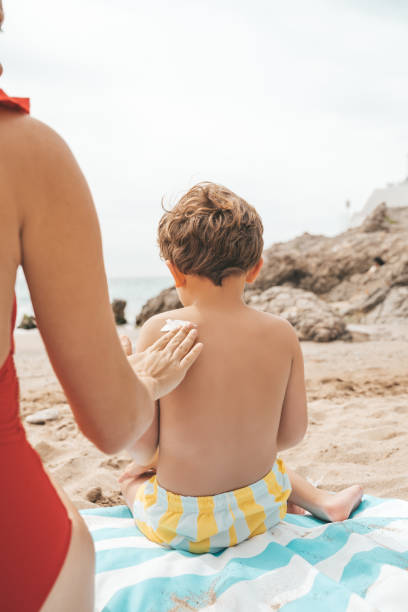 istock Mother applying sunscreen to her child 1155212921