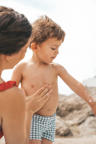 istock Mother applying sunscreen to her child 1155212961