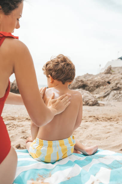 istock Mother applying sunscreen to her child 1155212965