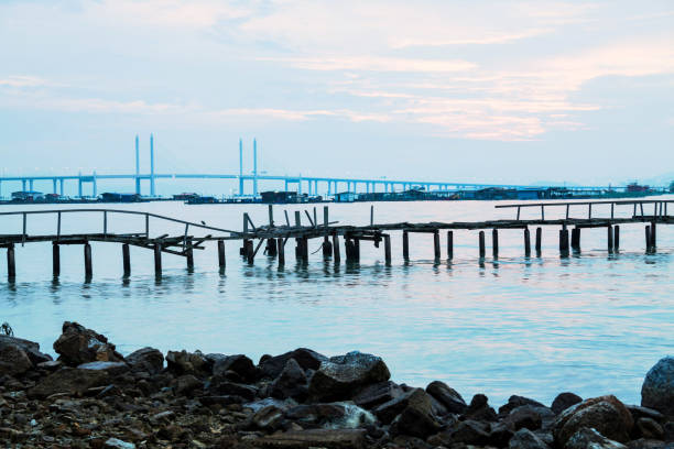 istock Long exposure view of a bridge by shore in black and white 1155213565
