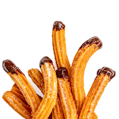 Churros - fried dough pastry with sugar and chocolate sauce dip isolated on a white background. Churro sticks, traditional Spanish snack