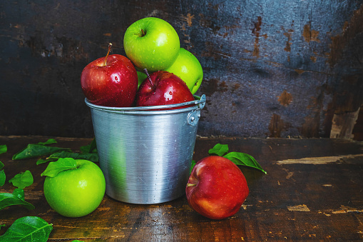 Fresh fruit, green apple and red apple in a bucket