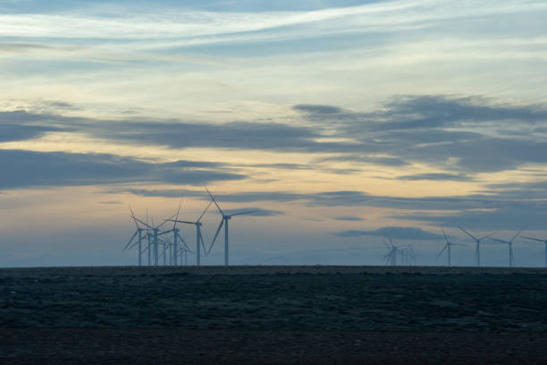 istock Windmill landscape at winter and sunset sillouettes 1155214039