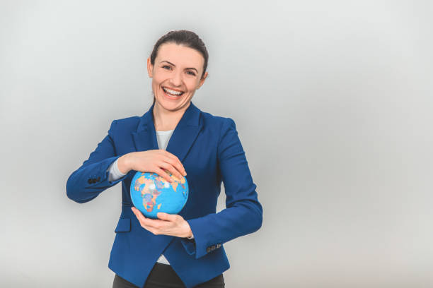 istock Young geography teacher holding a globe, looking at the camera, smiling. 1155214117