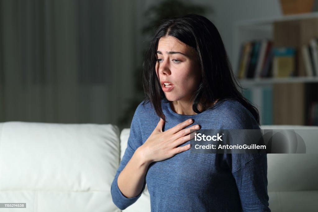 Woman suffering an anxiety attack alone in the night Anxiety Stock Photo