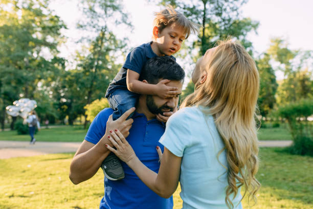 istock Parents play in the park with their son 1155214663