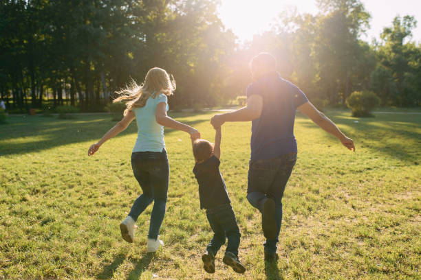 istock Parents play in the park with their son 1155214665