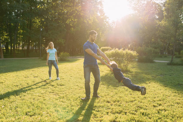 istock Parents play in the park with their son 1155214705