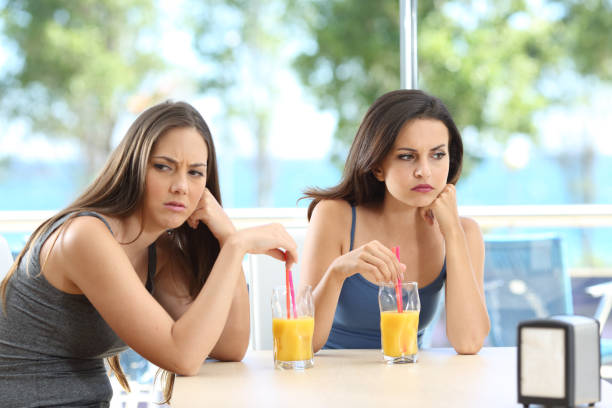 istock Angry friends ignoring each other on vacation 1155215533