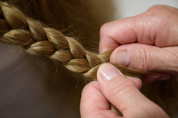 istock Grandmother make pigtail her granddaughter. 1155219307