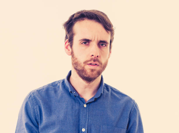 istock Young sad man suffering from depression. Worried and concerned hipster looking depressed and desperate feeling sorrow. Portrait with copy space. In People, human emotions and mental health concept. 1155221055