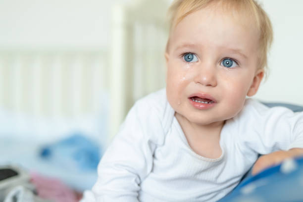 carino ritratto di bambino biondo caucasico che piange a casa durante l'isterica. il bambino si sente triste. piccolo bambino pensile dopo quarell - quarell foto e immagini stock